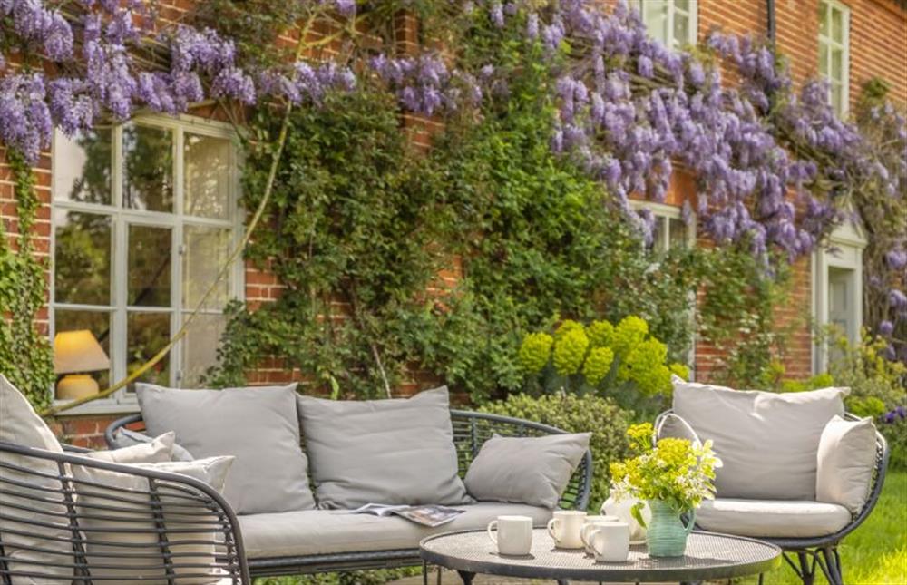 Stunning wisteria surrounds the outdoor furniture at Art Farmhouse, Saxmundham