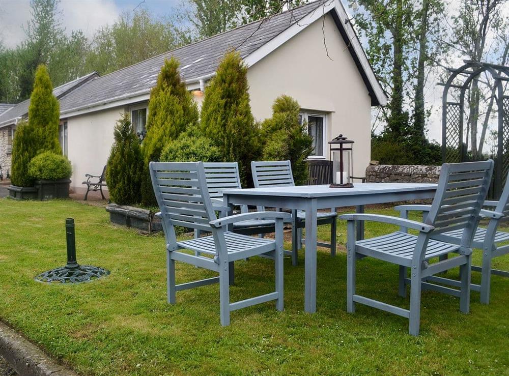 Lawned garden with outdoor dining area at Ash Cottage in Llantwit Major, near Cowbridge, Glamorgan, South Glamorgan