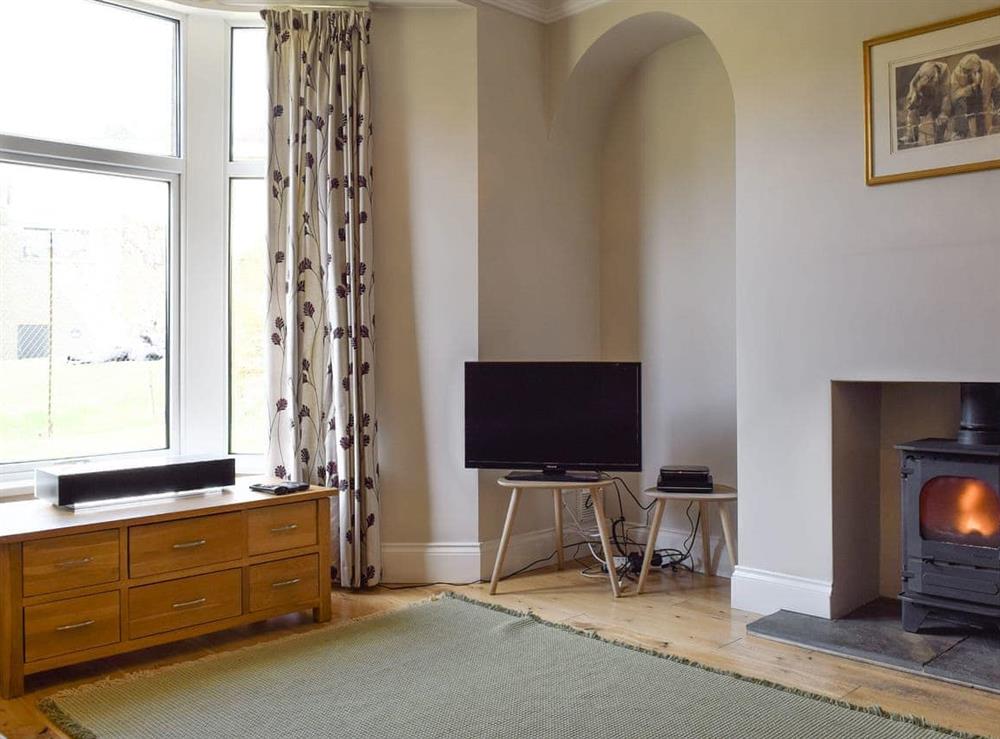 Warming wood burner within living room at Ash Grove in Skipton, North Yorkshire