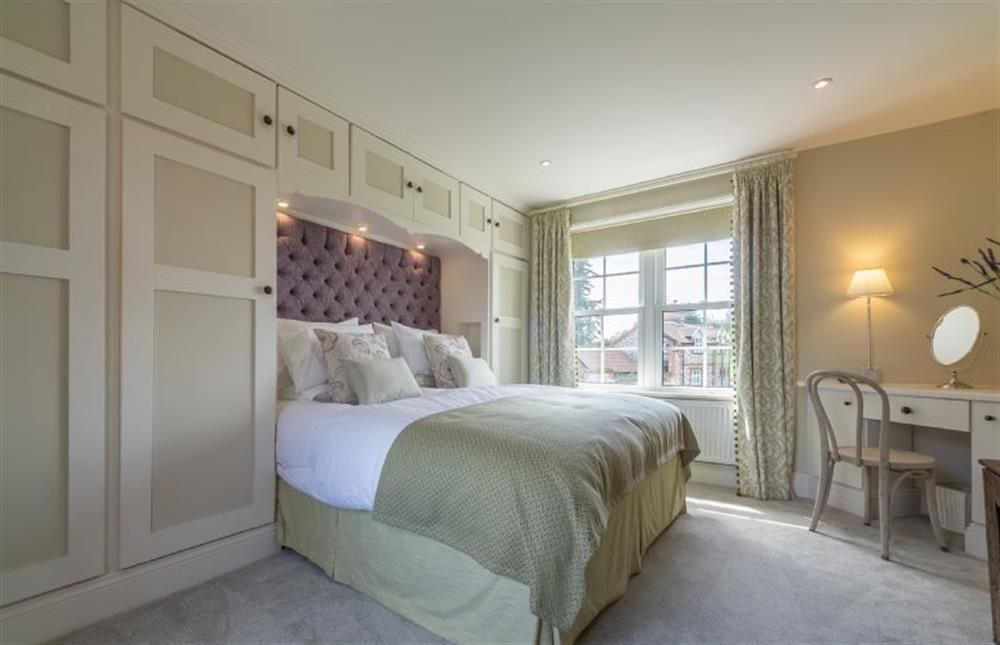 First floor: Duel aspect Master bedroom with king-size bed at Ashdale, Thornham near Hunstanton