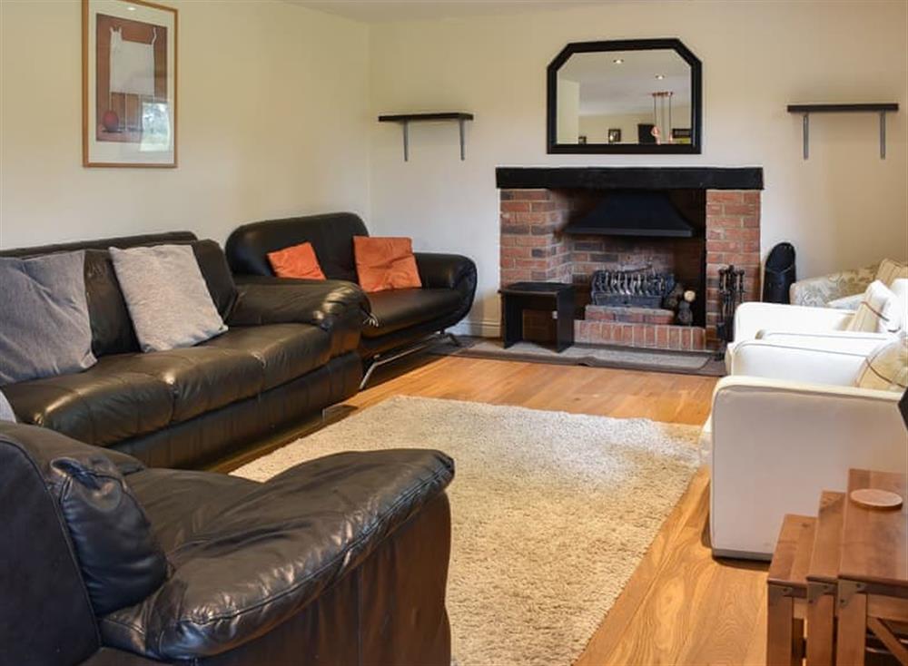 Comfortable and cosy living area with open fireplace at Ashdene Cottage in South Marston, Wiltshire