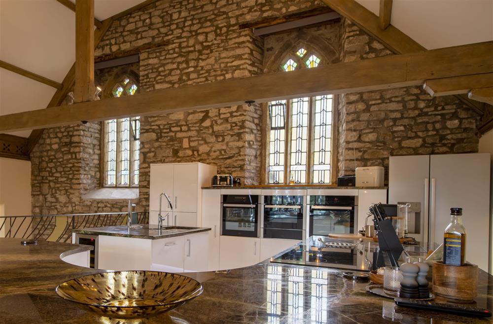 Well-equipped kitchen with modern appliances and beautiful exposed brick work at Askrigg Chapel, Askrigg, North Yorkshire