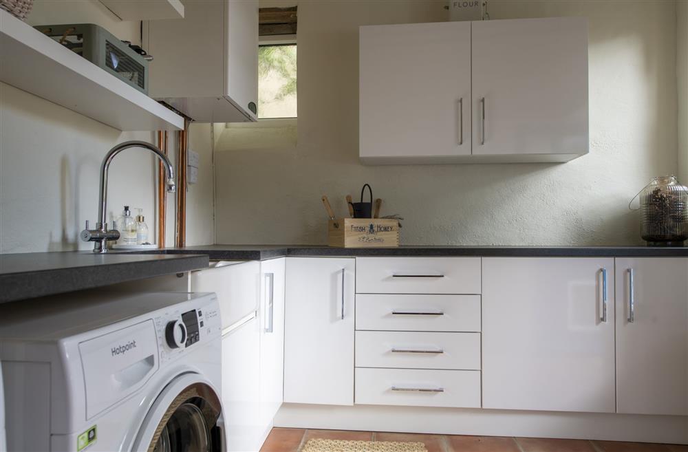 Well equipped utility room with washing machine and tumble dryer