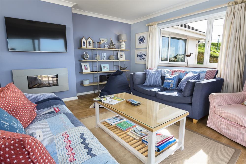 Living room with fantastic sea views towards Burgh Island and Bigbury Bay at Atlantic Lodge in Hope Cove, Kingsbridge