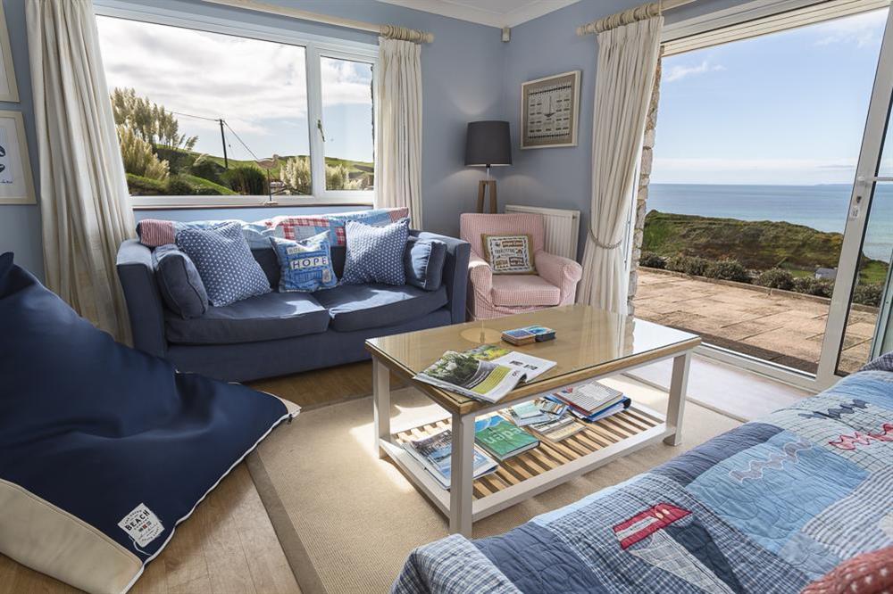 Living room with glorious sea views and doors leading to the furnished patio at Atlantic Lodge in Hope Cove, Kingsbridge