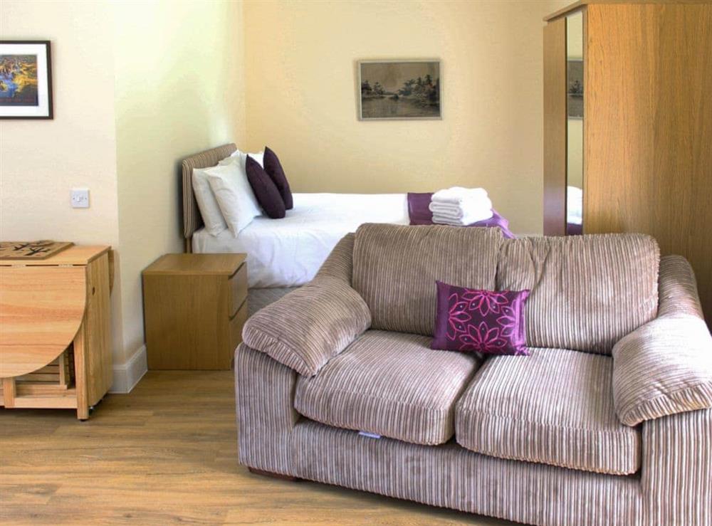 Open plan living/dining room/kitchen/bedroom (photo 2) at Chestnut Cottage, 