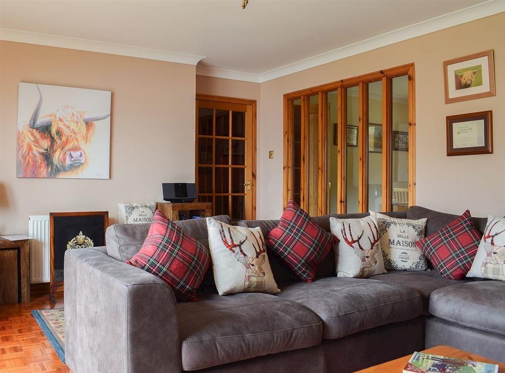 Comfortable sofas in the living room at Auchraw Brae in Lochearnhead, Perthshire
