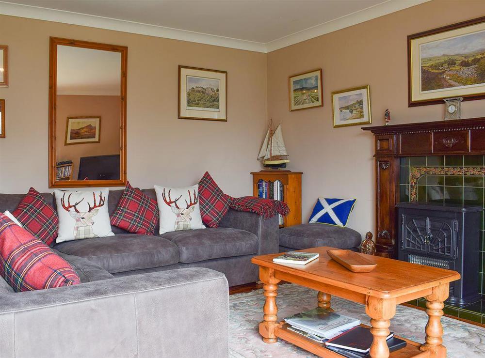 Delightful cosy living room with open fireplace at Auchraw Brae in Lochearnhead, Perthshire