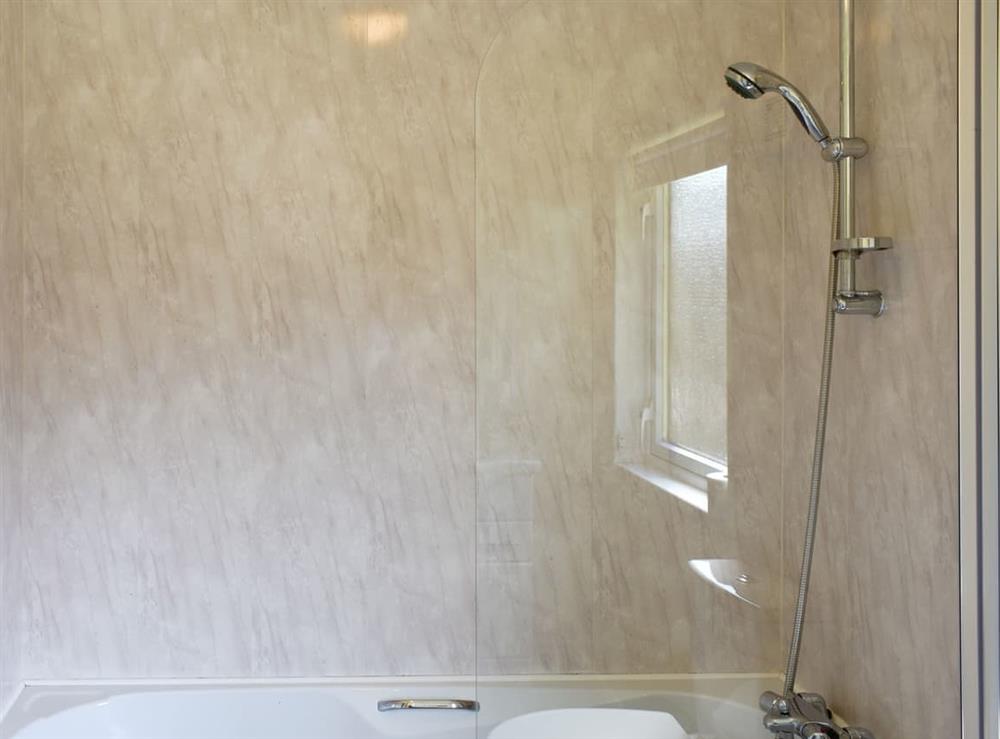 Family bathroom with shower over bath at Willow Cottage, 