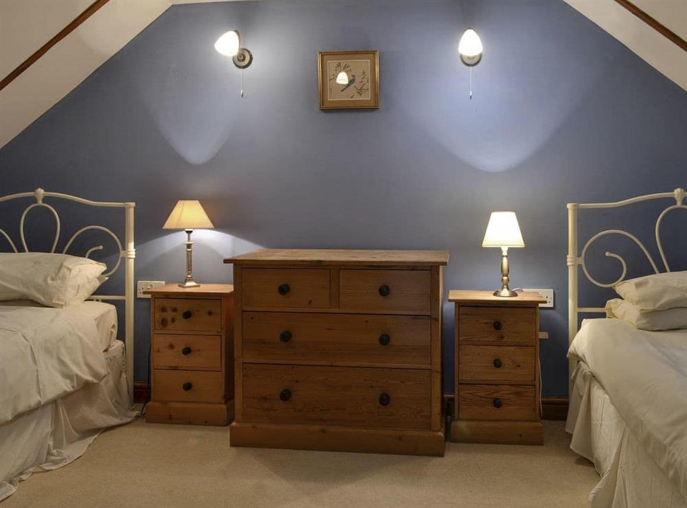 Comfortable twin bedroom at Aunt Nell’s Cottage in Hartland, Devon