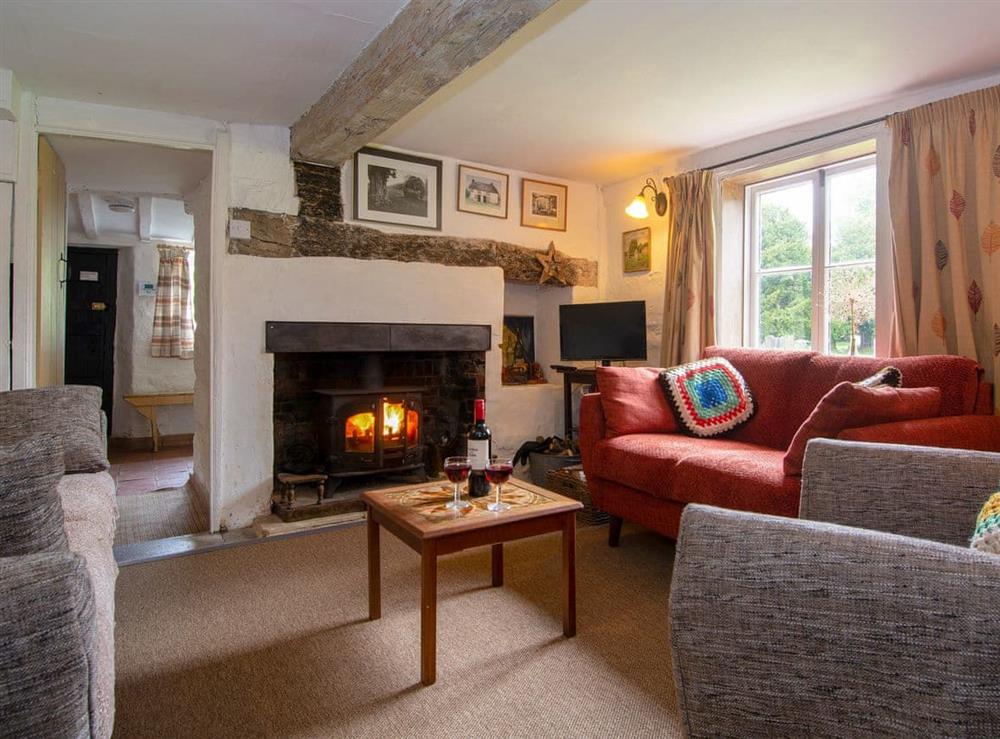 Cosy living room with wood burner at Avebury Cottage in Avebury, Wiltshire