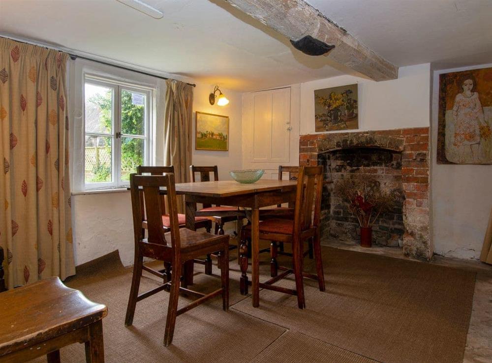 Dining room with beams and low ceiling at Avebury Cottage in Avebury, Wiltshire
