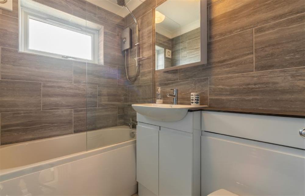 First floor: Modern bathroom with bath and shower over at Avocet Apartment, Wells-next-the-Sea