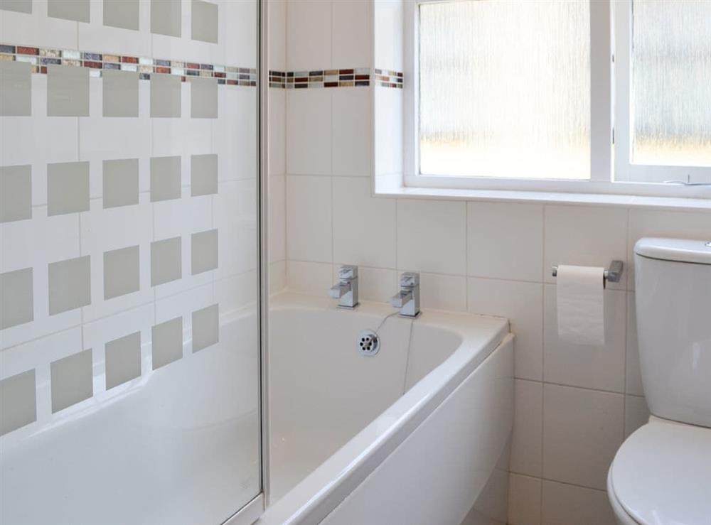 Bathroom with shower over the bath at Avocet Cottage in Sheringham, Norfolk