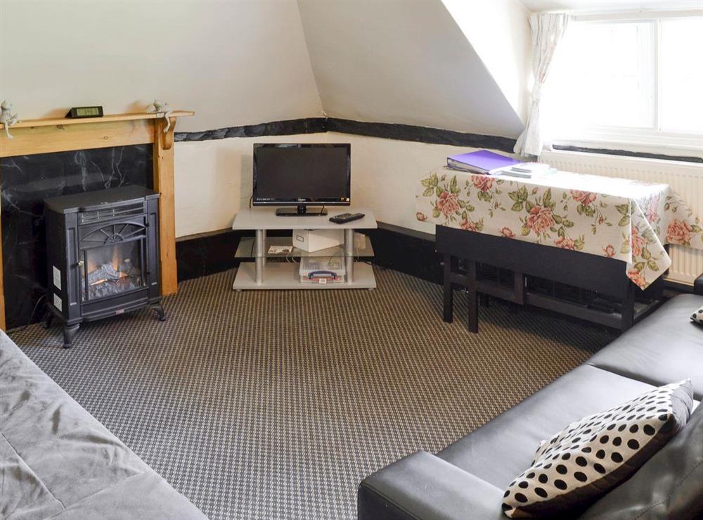 Cosy living area with wood burner at Avon View, 