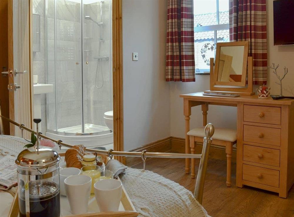 Comfortable double bedroom with en-suite shower room at Aysgarth Lodge in Seamer, near Scarborough, North Yorkshire