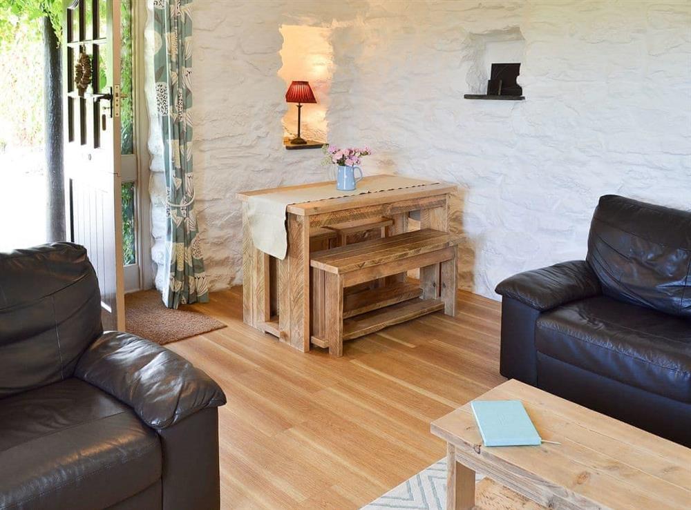 Charming living/dining room with door to the outside areas at Babes Cottage in Goonhavern, near Perranporth, Cornwall