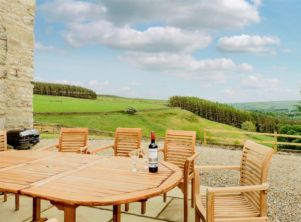 Large enclosed garden with sitting-out area and garden furniture at Backstone Bank Farmhouse in Wolsingham, near Stanhope, Durham