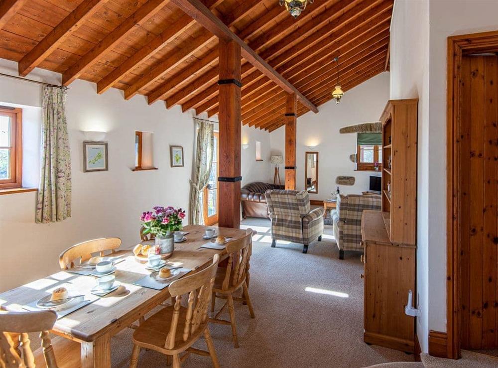 Beamed living/dining room at Badger Cottage in Gulworthy, near Tavistock, Devon