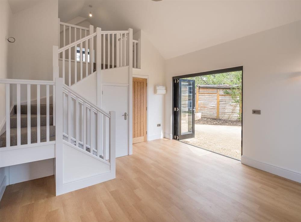 Large living area with stairs to mezzanine level at Badgers Brook in Brook, near Brighstone, Isle of Wight