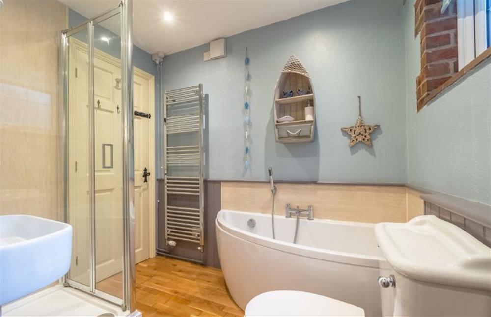 The bathroom has bath and separate shower at Badgers Den, Heacham near Kings Lynn