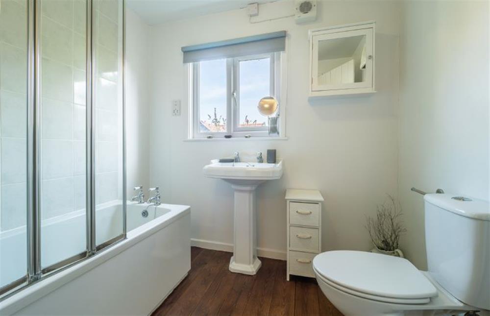 Bathroom with bath with rainfall shower, wash basin and WC at Bailey Cottage, Orford