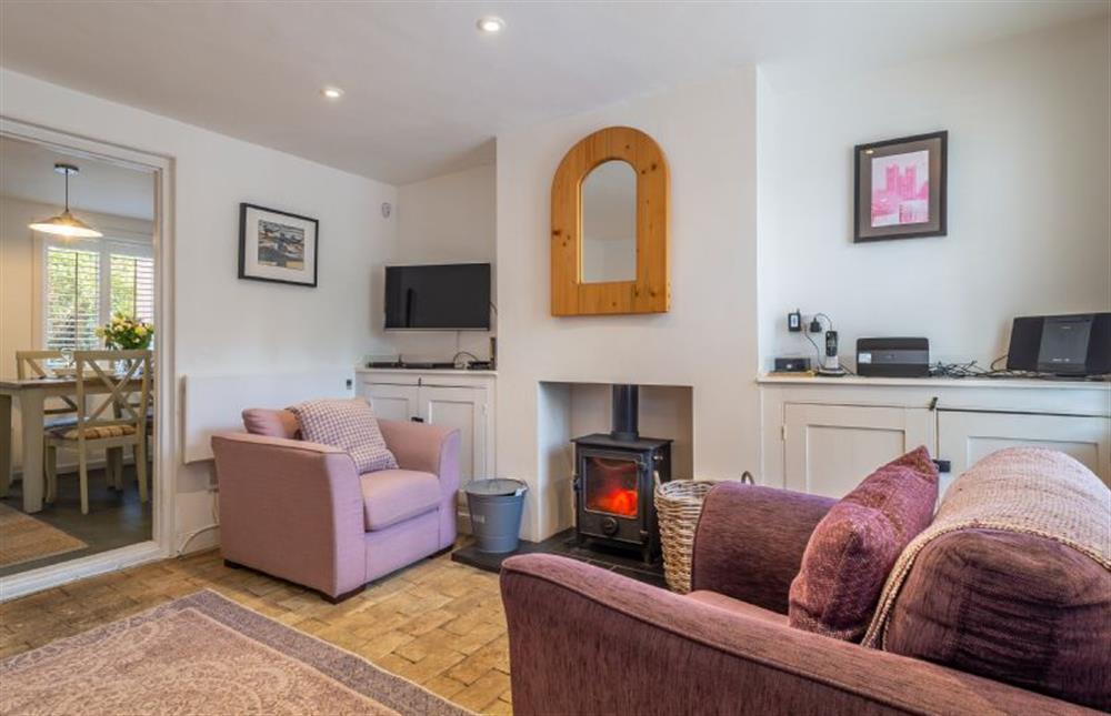 Sitting room with wood burning stove at Bailey Cottage, Orford