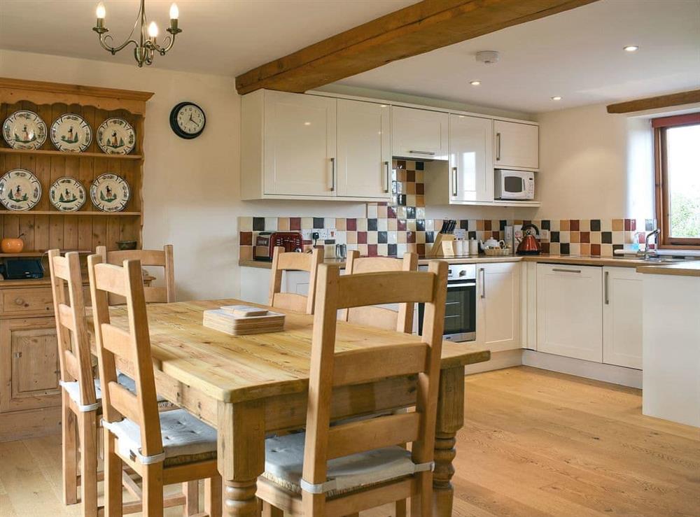 Large, beamed, open-plan living/dining room and kitchen area at Cowleaze, 