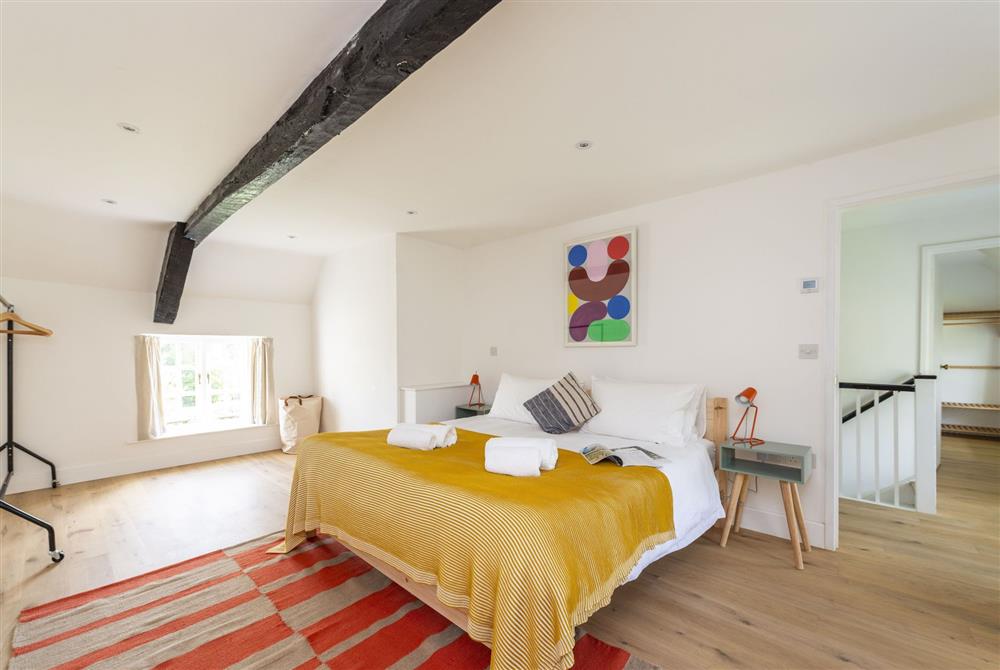Bedroom one with super-king size bed and en-suite bathroom at Bake House Cottage, Clifton Maybank, Nr Sherborne