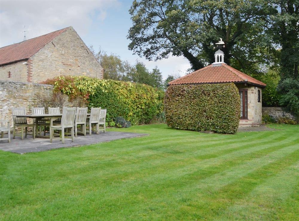 Large garden with seating area at Bakers Cottage in Hotham, near Beverley, North Yorkshire