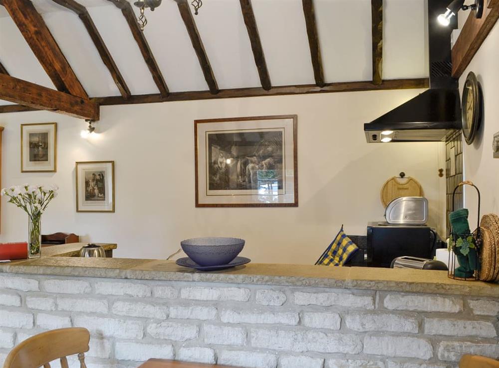 Kitchen viewed from the dining area at Bakery Cottage in Cirencester, Gloucestershire