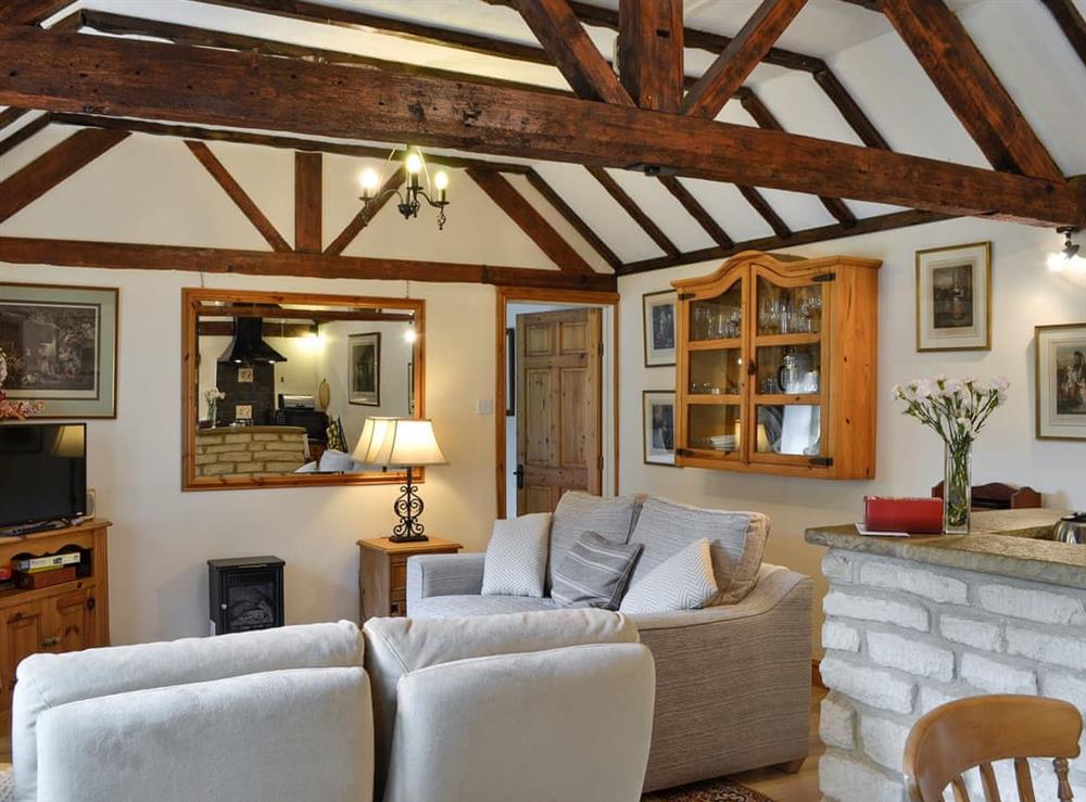 Open-plan living room with dining area and kitchen at Bakery Cottage in Cirencester, Gloucestershire