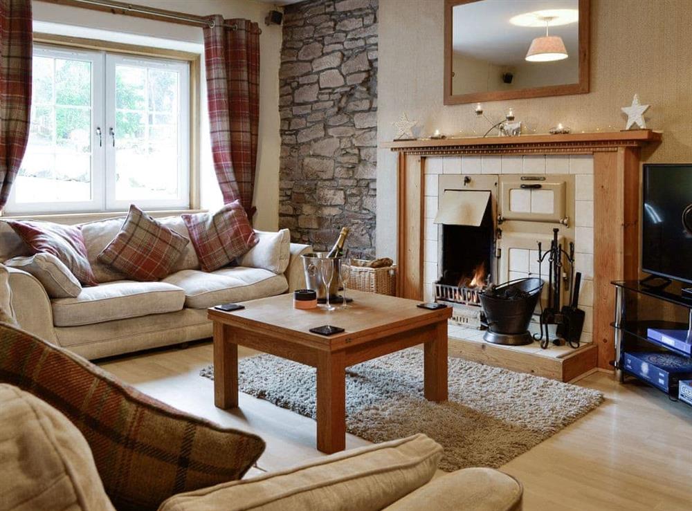 Welcoming living area with open fire at Baldowrie Farm Cottage in Kettins, near Blairgowrie, Perthshire