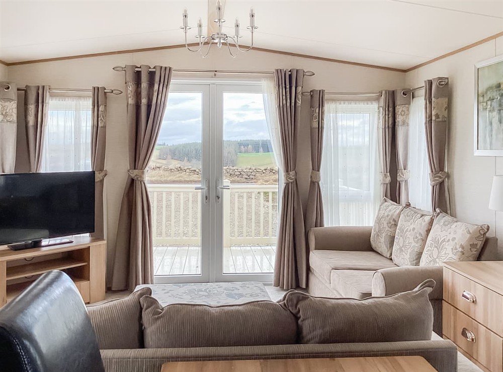 Open plan living space at Ballagan Lodge 2 in Inverness, Inverness-Shire