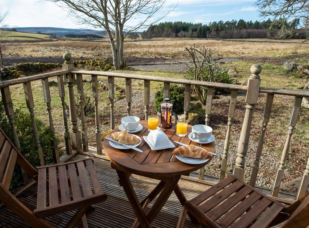 Decked area with garden furniture at Balloan Farm Cottage in Lairg, Highlands, Sutherland