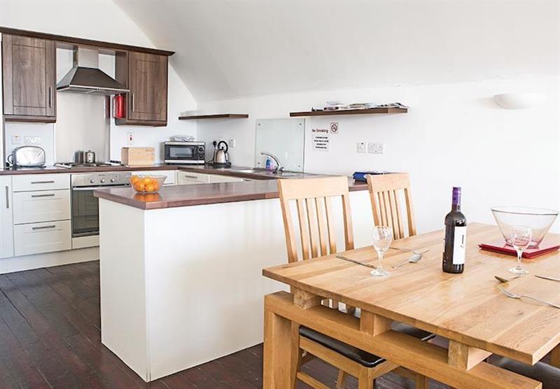 Kitchen and dining area in a Benandonners Barn Apartment at Ballylinney Holiday Cottages in Bushmills, Northern Ireland