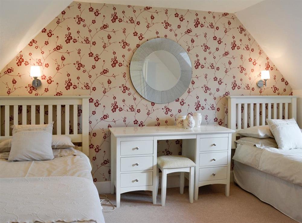 Pretty bedroom with twin beds at Balnowlart Lodge in Ballantrae, Ayrshire