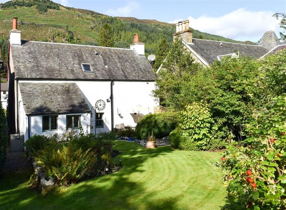 Large lawned garden with sitting-out areas at Balvaig Cottage in Strathyre, near Callander, Perthshire