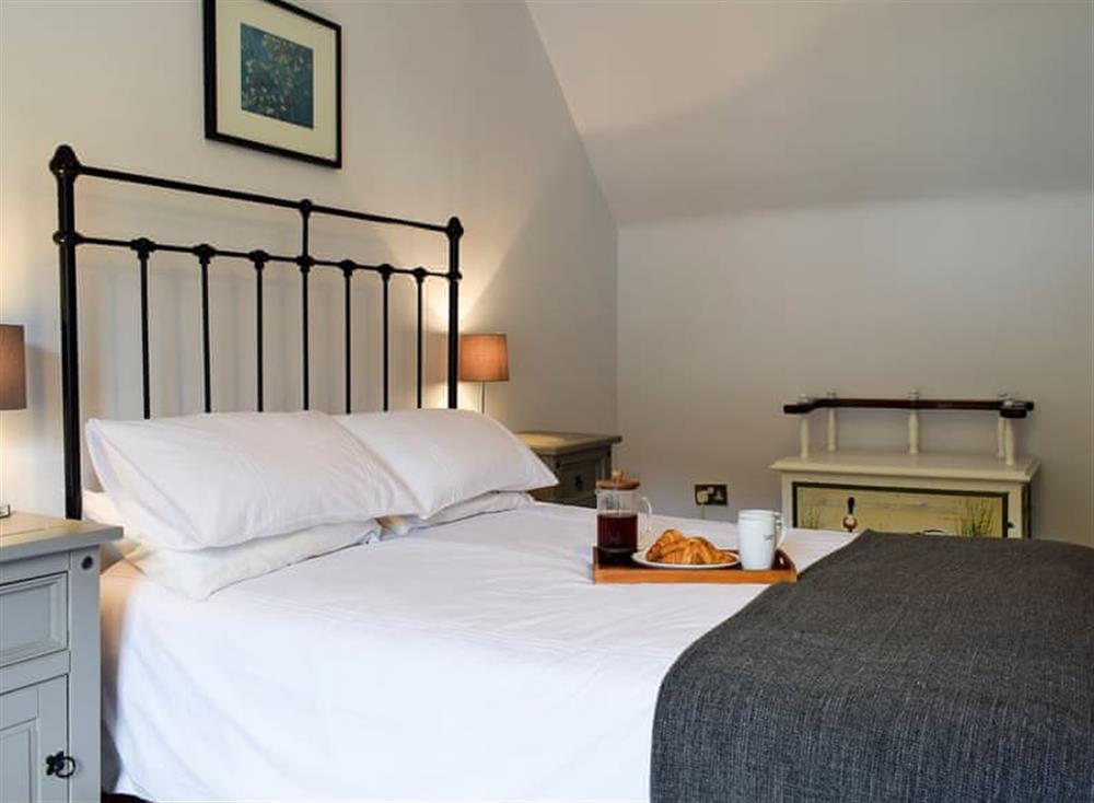 Master bedroom with kingsize bed at Balvaig Cottage in Strathyre, near Callander, Perthshire