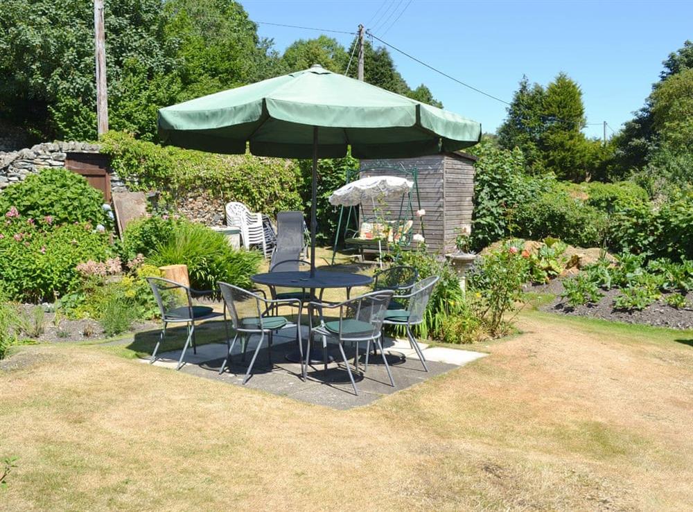 Well-maintained garden with outdoor furniture at Bandrake Barn in Oxen Park, near Ulverston, Cumbria