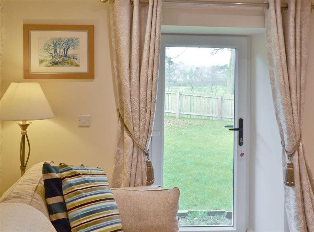 Glass door leading from lounge to garden at River View Cottage, 