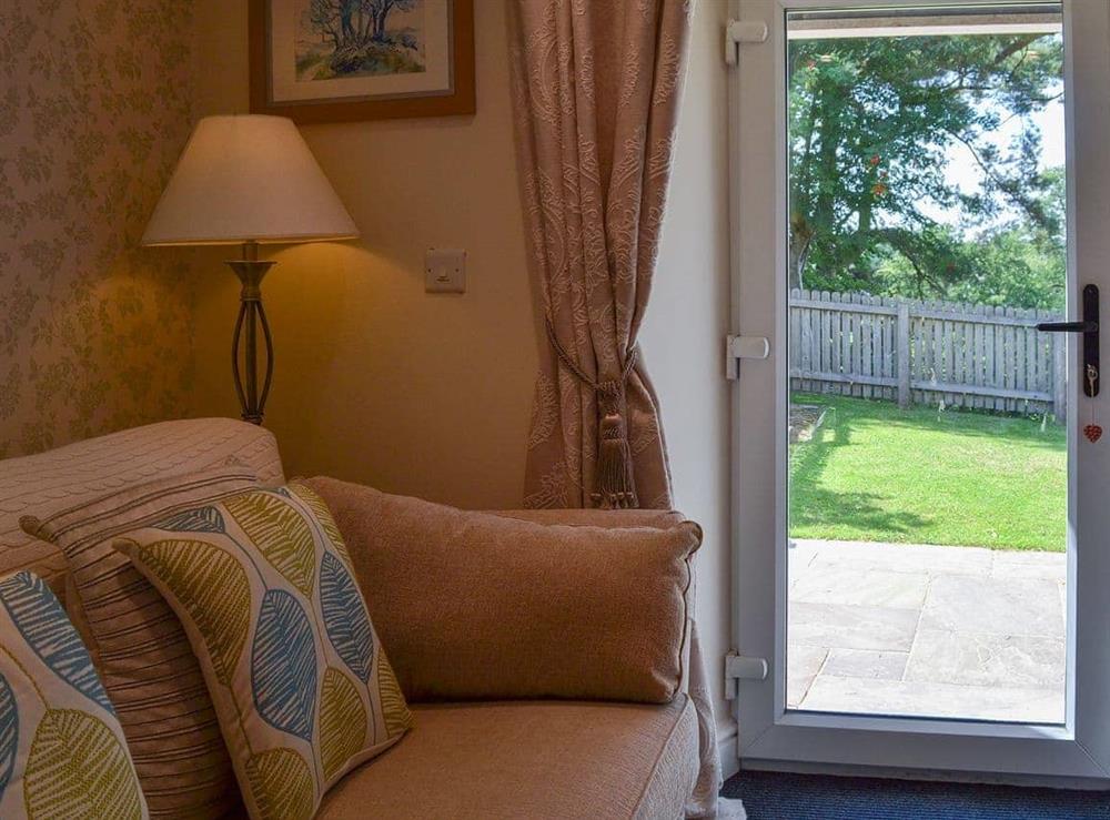 Lovely living room with patio access at River View Cottage, 