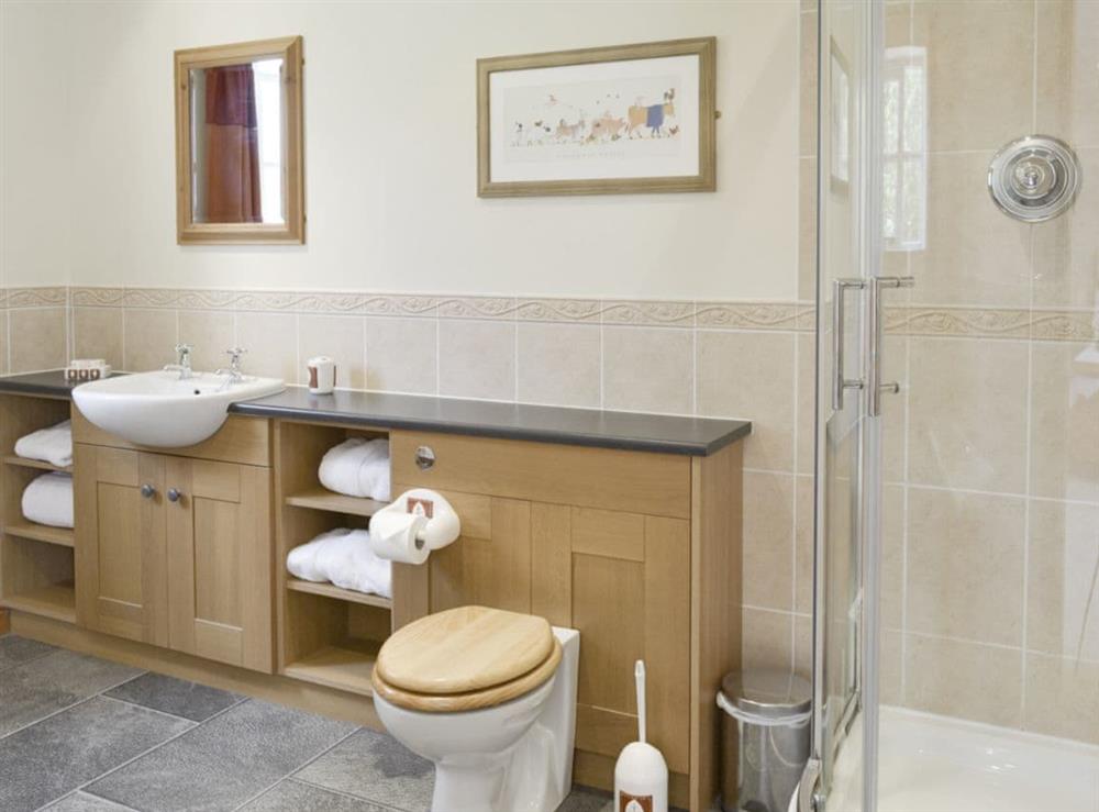 En-suite bathroom with shower cubicle and bath at Bank Top Cottage in Pickering, North Yorkshire
