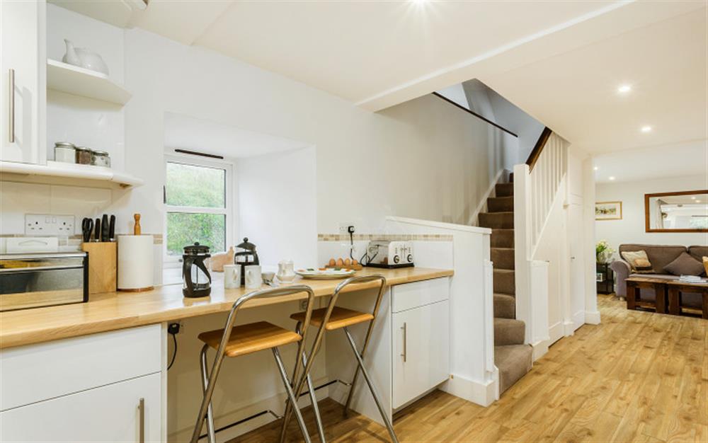 Kitchen area with breakfast bar at Bantam Cottage in Ottery St Mary