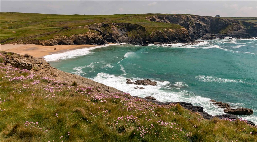 Visitors in the distance on the sandy beach at Bar Lodge in Helston, Cornwall