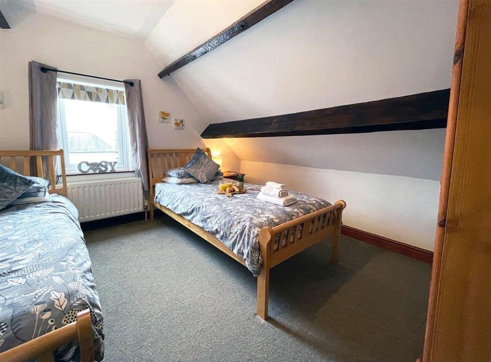 Comfortable twin bedroom with wardrobe at Baree in Keswick, Cumbria