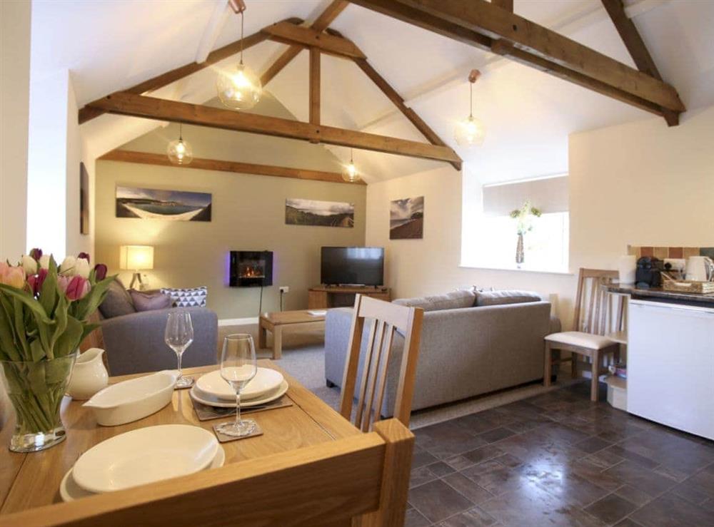 Living room with beams/dining room/kitchen at Barley Cottage in Ryme Intrinseca, near Sherborne, Dorset