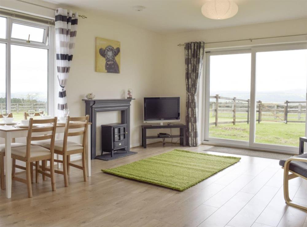 Open plan living and dining area with patio door to garden at Barley Heights in Hapton, Lancashire