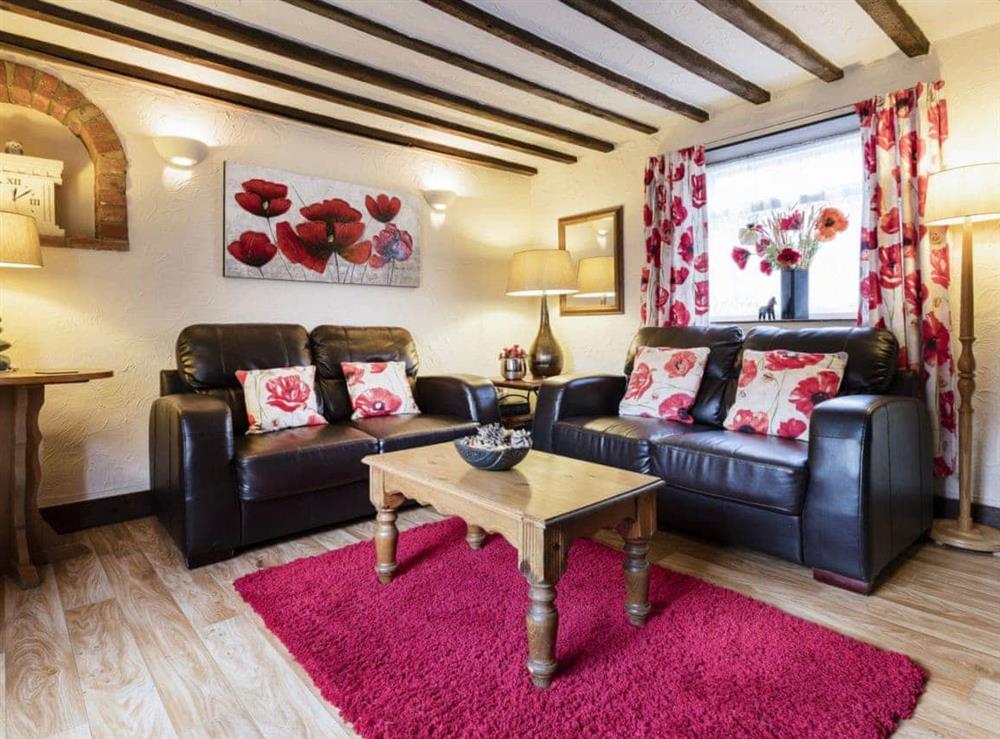 Cosy living room with beamed ceiling at Barmstone Cottage in Brancaster, Norfolk., Great Britain