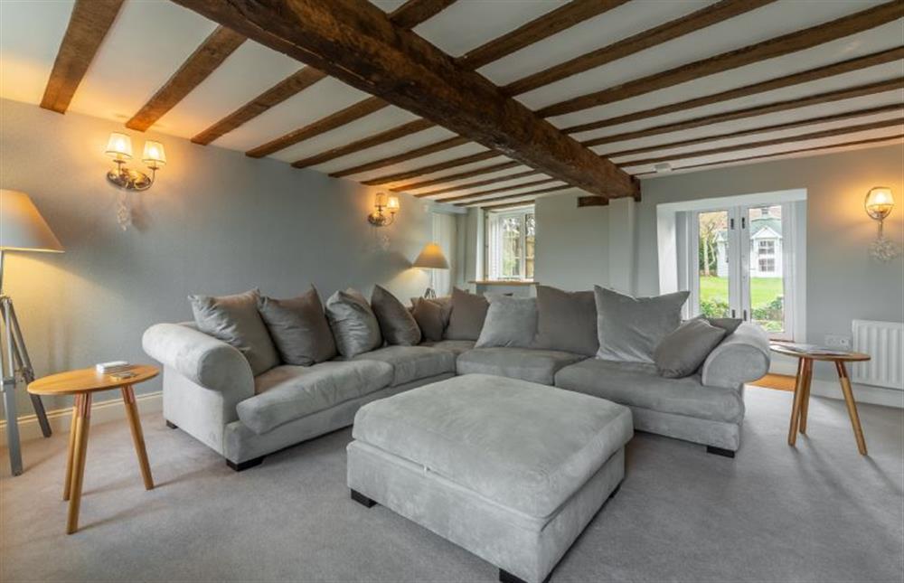 Barn Cottage: Sitting room with beams, stunning views of the marshes to the front and double doors to the rear garden